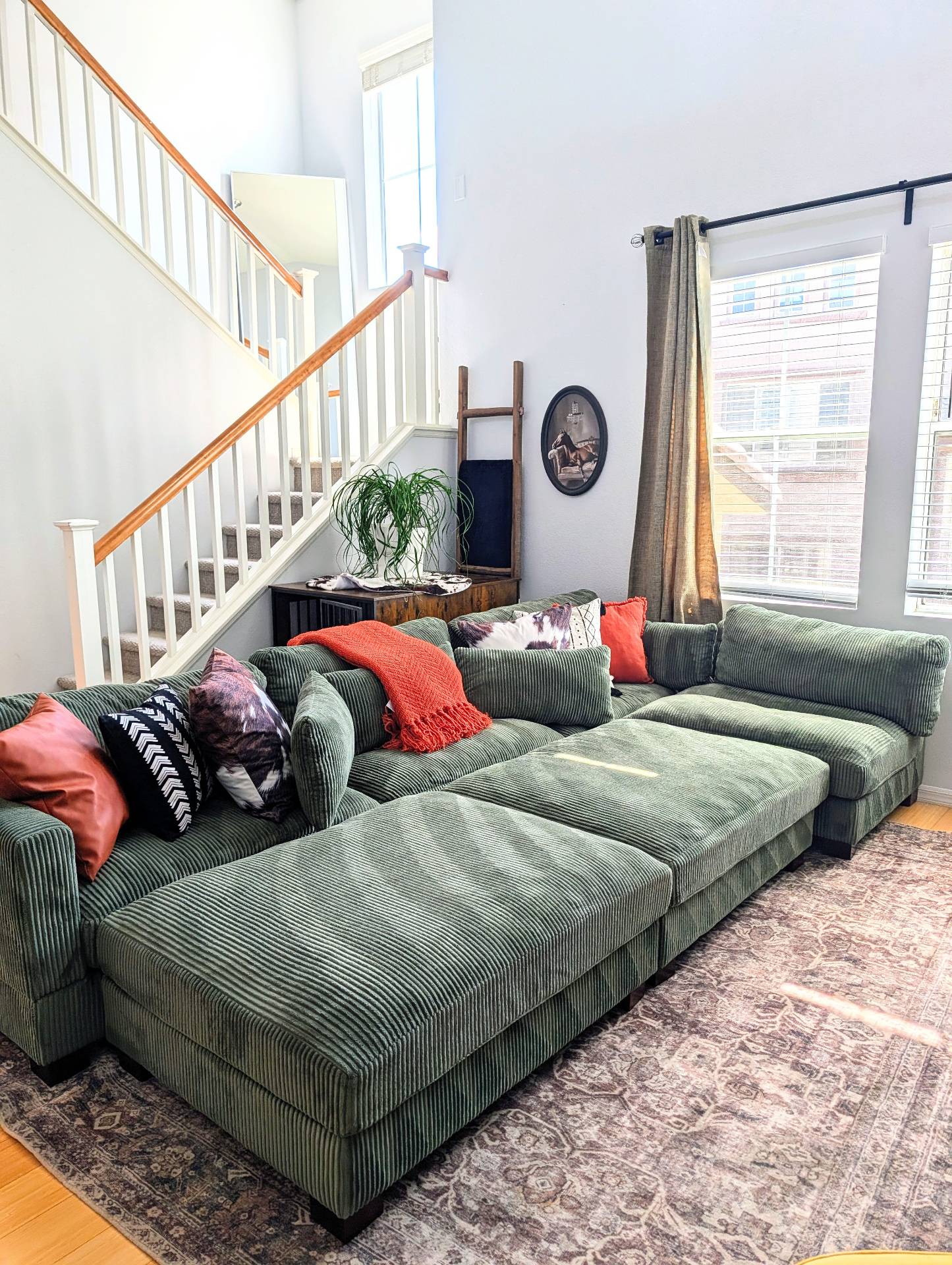 Cozy Las Vegas living room with a green corduroy sectional, freshly cleaned